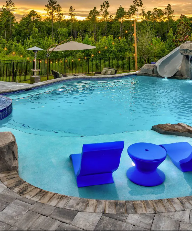 Swimming Pool with blue sun loungers, waterfall & spa - Kerry Martin Pools